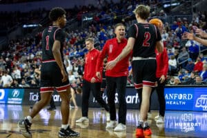 South Dakota Coyote head coach Eric Peterson talks to a play at a break in the action against the Nebraska-Omaha Mavericks in the first half during the Summit League Tournament Saturday, March 8, 2025 in Sioux Falls, South Dakota. Photo by John S. Peterson.