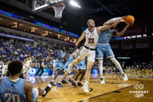 Nebraska-Omaha Mavericks forward Joshua Streit (23) reaches for the ball against UMKC Kangaroos guard Jayson Petty (1) during the Summit League Tournament Thursday, March 6, 2025 in Lincoln, Nebraska. Photo by John S. Peterson.
