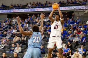 Nebraska-Omaha Mavericks forward Marquel Sutton (10) makes a three point shot against UMKC Kangaroos center Melvyn Ebonkoli (20) during the Summit League Tournament Thursday, March 6, 2025 in Lincoln, Nebraska. Photo by John S. Peterson.