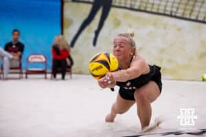Nebraska Cornhusker Keri Leimbach (10) lunges forward for the ball against the Ottawa Braves during a college beach volleyball match Tuesday, March 4, 2025 in Lincoln, Nebraska. Photo by John S. Peterson.