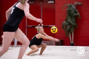 Nebraska Cornhusker Keri Leimbach (10) digs the ball against the Ottawa Braves during a college beach volleyball match Tuesday, March 4, 2025 in Lincoln, Nebraska. Photo by John S. Peterson.