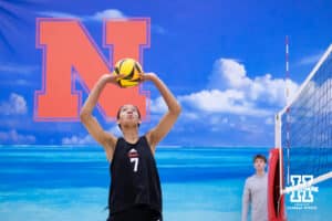Nebraska Cornhusker Taylor Landfair (7) sets the ball against the Ottawa Braves during a college beach volleyball match Tuesday, March 4, 2025 in Lincoln, Nebraska. Photo by John S. Peterson.
