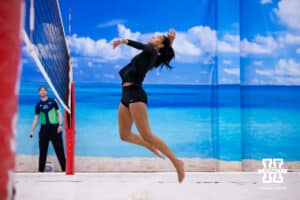 Nebraska Cornhusker Harper Murray (8) jumps to spike the ball against the Ottawa Braves during a college beach volleyball match Tuesday, March 4, 2025 in Lincoln, Nebraska. Photo by John S. Peterson.