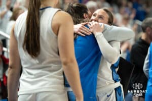 Creighton Bluejays Molly Mogensen hugs a coach after checking out during a college basketball game against Villanova on March 2nd, 2025 in Omaha Nebraska. Photo by Brandon Tiedemann.