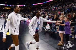 Omaha Supernovas Toyosi Onabanjo (21) and Omaha Supernovas Kelsie Payne (11) give fives to some fans as the head to the locker room after the sweep against the Indy Ignite during a professional volleyball match Sunday, March 2, 2025 in Omaha, Nebraska. Photo by John S. Peterson.