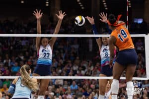 Omaha Supernovas Kaitlyn Hord (23) and Omaha Supernovas Reagan Cooper (8) jump to block a spike for Indy Ingite Azhani Tealer (19) in the second set during a professional volleyball match Sunday, March 2, 2025 in Omaha, Nebraska. Photo by John S. Peterson.