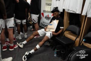 Omaha Mavericks Marquel Sutton holds the trophy after a college basketball game against Oral Roberts on March 1st, 2025 in Omaha Nebraska. Photo by Brandon Tiedemann.