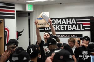 Omaha Mavericks Joshua Streit hoists the trophy after a college basketball game against Oral Roberts on March 1st, 2025 in Omaha Nebraska. Photo by Brandon Tiedemann.