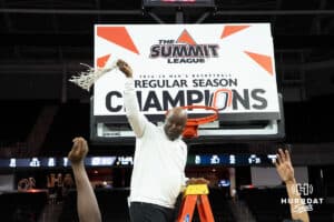 Omaha Mavericks Coach Crutchfield cuts the net after a college basketball game against Oral Roberts on March 1st, 2025 in Omaha Nebraska. Photo by Brandon Tiedemann.