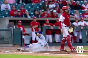 Kansas St. Wildcat infielder Shintaro Inoue (5) scores in the seventh inning against Nebraska Cornhusker catcher Hogan Helligso (10) during a college baseball game Tuesday, April 29, 2025 in Lincoln, Nebraska. Photo by John S. Peterson.