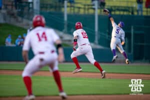 Kansas St. Wildcat infielder Shintaro Inoue (5) jumps missing Nebrasska's Helligso hit to center driving home Tyler Stone (55) from second and advances Case Sanderson (14) to second during a college baseball game Tuesday, April 29, 2025 in Lincoln, Nebraska. Photo by John S. Peterson.