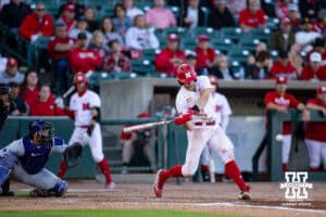 Nebraska Cornhusker infielder Dylan Carey (15) singles in the sixth inning against the Kansas St. Wildcats during a college baseball game Tuesday, April 29, 2025 in Lincoln, Nebraska. Photo by John S. Peterson.