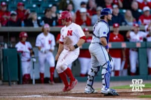 Nebraska Cornhusker utility Max Buettenback (11) scores from Sanderson's single in the sixth inning against the Kansas St. Wildcats during a college baseball game Tuesday, April 29, 2025 in Lincoln, Nebraska. Photo by John S. Peterson.