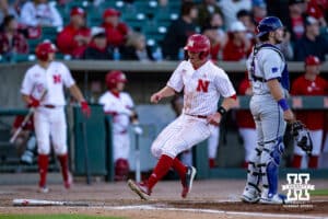 Nebraska Cornhusker utility Max Buettenback (11) scores from Sanderson's single in the sixth inning against the Kansas St. Wildcats during a college baseball game Tuesday, April 29, 2025 in Lincoln, Nebraska. Photo by John S. Peterson.