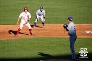 Nebraska Cornhusker infielder Dylan Carey (15) leads off as Kansas St. Wildcat pitcher Tanner Duke (55) checks him out during a college baseball game Tuesday, April 29, 2025 in Lincoln, Nebraska. Photo by John S. Peterson.