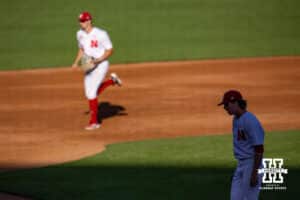 Nebraska Cornhusker infielder Dylan Carey (15) runs to the dugout as pitcher Colin Nowaczyk (47) walks against the Kansas St. Wildcats during a college baseball game Tuesday, April 29, 2025 in Lincoln, Nebraska. Photo by John S. Peterson.