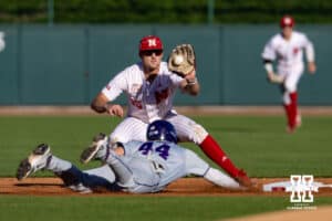 Nebraska Cornhusker infielder Dylan Carey (15) catches the ball as Kansas St. Wildcat David Bishop (44) dives to second base during a college baseball game Tuesday, April 29, 2025 in Lincoln, Nebraska. Photo by John S. Peterson.