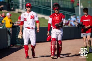 Nebraska Cornhusker starting pitcher Tucker Timmerman (32) and catcher Hogan Helligso (10) walk down to the dougout to start the game against the Kansas St. Wildcats during a college baseball game Tuesday, April 29, 2025 in Lincoln, Nebraska. Photo by John S. Peterson.