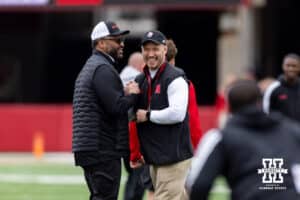 Former Husker Jay Moore and Will Compton shake hands during Husker games Saturday, April 26, 2025 in Lincoln, Nebraska. Photo by John S. Peterson.
