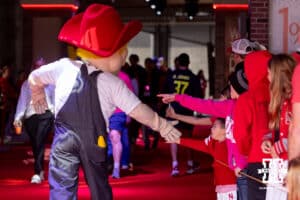Herbie gives five to a young fan during Husker games Saturday, April 26, 2025 in Lincoln, Nebraska. Photo by John S. Peterson.