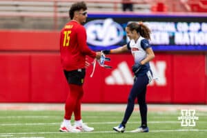 The Midland player hands Nebraska quarterback Dylan Raiola his flag belt back after tackling him during Husker games Saturday, April 26, 2025 in Lincoln, Nebraska. Photo by John S. Peterson.