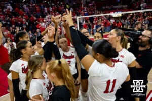 Nebraska Cornhuskers huddle up after the sweep of Kansas during a college volleyball match Saturday, April 26, 2025 in Lincoln, Nebraska. Photo by John S. Peterson.