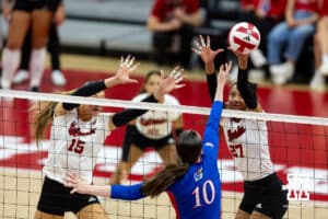 Nebraska Cornhusker Harper Murray (27) blocks a spike from Kansas Jayhawk Reese Ptacek (10) during a college volleyball match Saturday, April 26, 2025 in Lincoln, Nebraska. Photo by John S. Peterson.