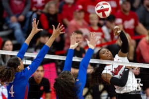 Nebraska Cornhusker Ryna Hunter (18) spikes the ball against the Kansas Jayhawks during a college volleyball match Saturday, April 26, 2025 in Lincoln, Nebraska. Photo by John S. Peterson.