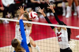 Nebraska Cornhusker Rebekah Allick (5) and Harper Murray jump up to block a shot from Kansas Jayhawk Ellie Schneider (15) during a college volleyball match Saturday, April 26, 2025 in Lincoln, Nebraska. Photo by John S. Peterson.