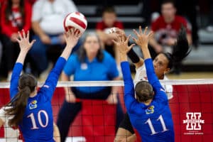 Nebraska Cornhusker Harper Murray (27) spikes the ball against Kansas Jayhawk Reese Ptacek (10) and Cristin Cline (11) during a college volleyball match Saturday, April 26, 2025 in Lincoln, Nebraska. Photo by John S. Peterson.