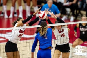 Nebraska Cornhuskers Skyler Pierce (21) and Andi Jackson jump up to block a spike from Kansas Jayhawk Rhian Swanson (4) during a college volleyball match Saturday, April 26, 2025 in Lincoln, Nebraska. Photo by John S. Peterson.