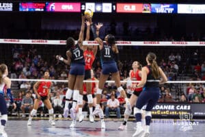 Omaha Supernovas Phoebe Awoleye (17) and Kelsie Payne (11) hit the ball over against Columbus Fury Janice Leao (14) during a college volleyball match Friday, April 25, 2025 in Omaha, Nebraska. Photo by John S. Peterson.