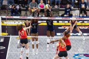 Omaha Supernovas Kelsie Payne (11) and Phoebe Awoleye (17) jump up to block a spike from Columbus Fury Megan Courtney-Lush (17) during a professional volleyball match Friday, April 25, 2025 in Omaha, Nebraska. Photo by John S. Peterson.
