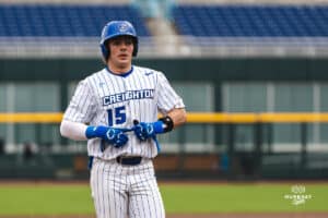 Creighton Bluejay Kyle Hess talking with a coach during a baseball game at Charles Schwab Field on Thursday, April 17th, 2025 in Omaha Nebraska. Photo by Collin Stilen.