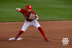 Nebraska Cornhusker utility Cayden Brumbaugh (0) throws to first going for a double-play against the Kansas Jayhawks during a college baseball game Tuesday, April 22, 2025 in Lincoln, Nebraska. Photo by John S. Peterson.