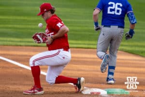 ebraska Cornhusker outfielder Robby Bolin (5) fumbles the ball against Kansas Jayhawk Brady Ballinger (26) during a college baseball game Tuesday, April 22, 2025 in Lincoln, Nebraska. Photo by John S. Peterson.