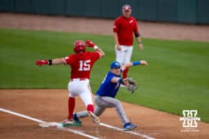 Nebraska Cornhusker infielder Dylan Carey (15) tries to make it to first against Kansas Jayhawk Brady Ballinger (26) during a college baseball game Tuesday, April 22, 2025 in Lincoln, Nebraska. Photo by John S. Peterson.