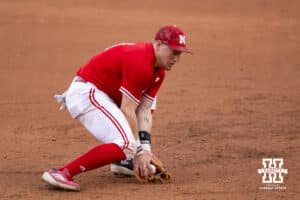 Nebraska Cornhusker infielder Josh Overbeek (4) scoops up the ball against the Kansas Jayhawks during a college baseball game Tuesday, April 22, 2025 in Lincoln, Nebraska. Photo by John S. Peterson.