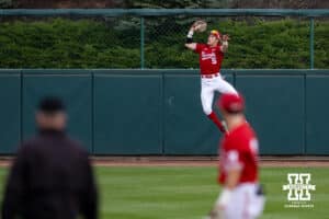 Nebraska Cornhusker outfielder Robby Bolin (5) jumps to make a catch at the wall against the Kansas Jayhawks during a college baseball game Tuesday, April 22, 2025 in Lincoln, Nebraska. Photo by John S. Peterson.