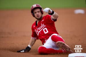 Nebraska Cornhusker utility Cayden Brumbaugh (0) slides at third base during a college baseball game Tuesday, April 22, 2025 in Lincoln, Nebraska. Photo by John S. Peterson.