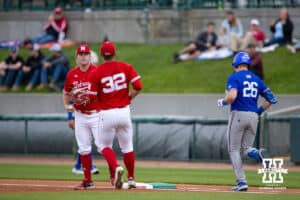 Kansas Jayhawk Brady Ballinger (26) grounds out to Nebraska Cornhusker pitcher Tucker Timmerman (32), tossing to Tyler Stone at first base during a college baseball game Tuesday, April 22, 2025, in Lincoln, Nebraska. Photo by John S. Peterson.