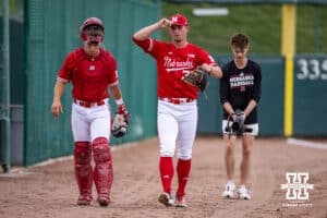 Nebraska Cornhusker catcher Will Jesske (13) and pitcher Tucker Timmerman (32) walk down to the dugout for the start of the game against the Kansas Jayhawks during a college baseball game Tuesday, April 22, 2025 in Lincoln, Nebraska. Photo by John S. Peterson.
