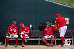 Nebraska Cornhusker pitcher Tucker Timmerman (32) and pitching coach Rob Childress, left, talking before taking on Kansas Jayhawks during a college baseball game Tuesday, April 22, 2025 in Lincoln, Nebraska. Photo by John S. Peterson.