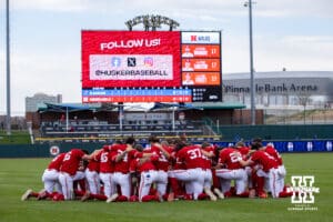 Nebraska Cornhuskers huddle up together before taking on the Kansas Jayhawks during a college baseball game Tuesday, April 22, 2025 in Lincoln, Nebraska. Photo by John S. Peterson.