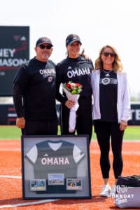 Sydney Thompson (19) poses with her parents on senior day Saturday, April 19, 2025 in Omaha, Nebraska. Photo by Braden Cochran.