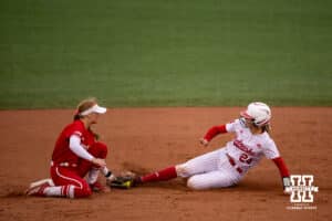 Nebraska Cornhusker Ava Bredwell (24) slides at second getting tagged against the Indiana Hoosiers during a college softball game Friday, April 18, 2025 in Omaha, Nebraska. Photo by John S. Peterson.