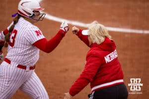 Nebraska Cornhusker head coach Rhonda Revelle gives Emmerson Cope a fist bump after hitting a home run against the Indiana Hoosiers during a college softball game Friday, April 18, 2025 in Omaha, Nebraska. Photo by John S. Peterson.