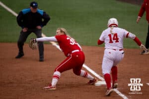 Nebraska Cornhusker Kacie Hoffmann (14) out at first against the Indiana Hoosiers during a college softball game Friday, April 18, 2025 in Omaha, Nebraska. Photo by John S. Peterson.