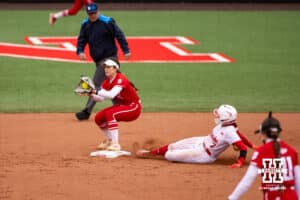 Nebraska Cornhusker Ava Kuszak (7) out at second against Indiana Hoosier Aly VanBrandt (5) during a college softball game Friday, April 18, 2025 in Omaha, Nebraska. Photo by John S. Peterson.