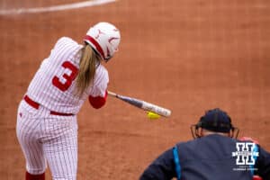 Nebraska Cornhusker Bella Bacon (3) gets a hit against the Indiana Hoosiers during a college softball game Friday, April 18, 2025 in Omaha, Nebraska. Photo by John S. Peterson.